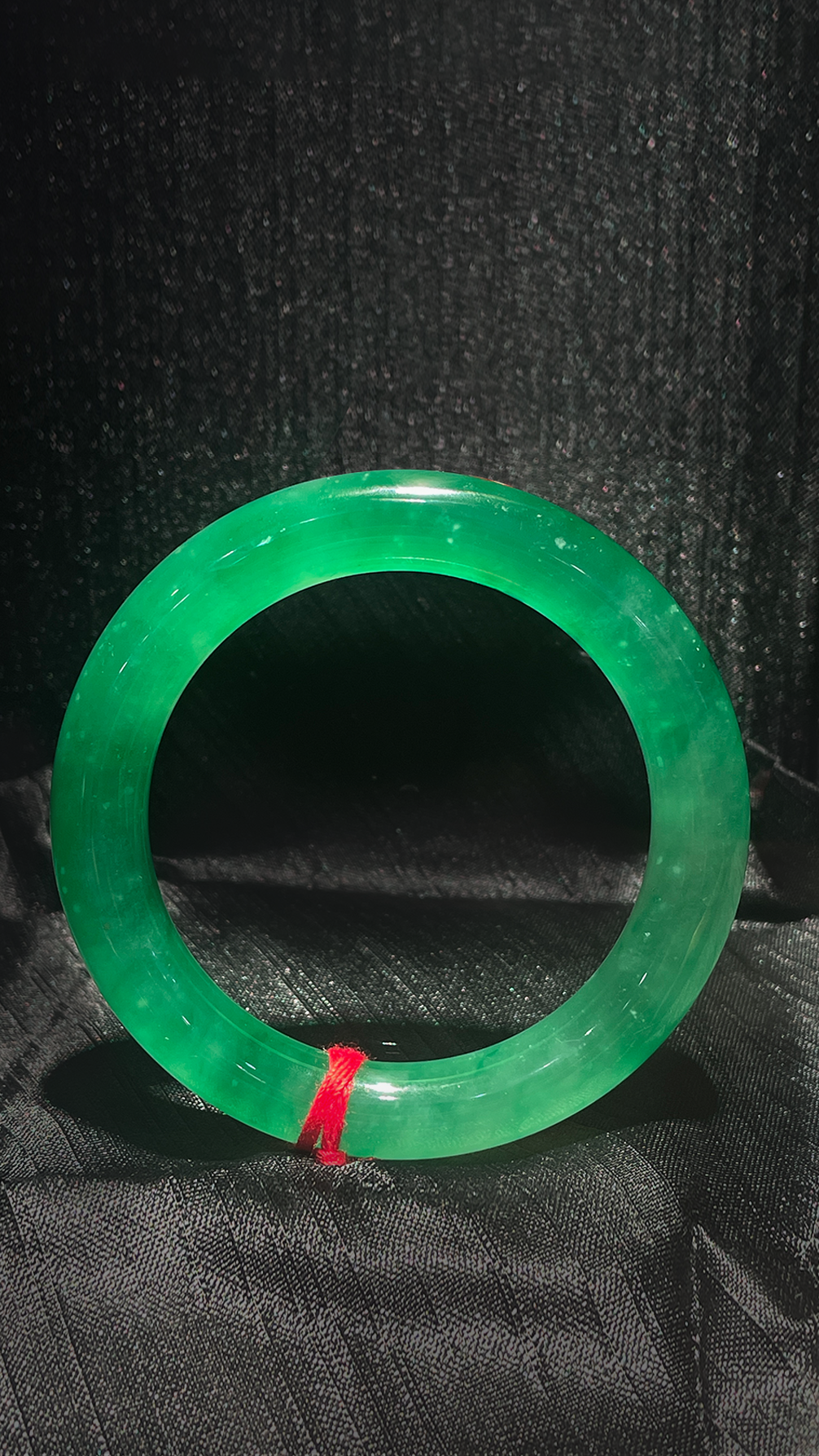 Green jade bracelet on a black background