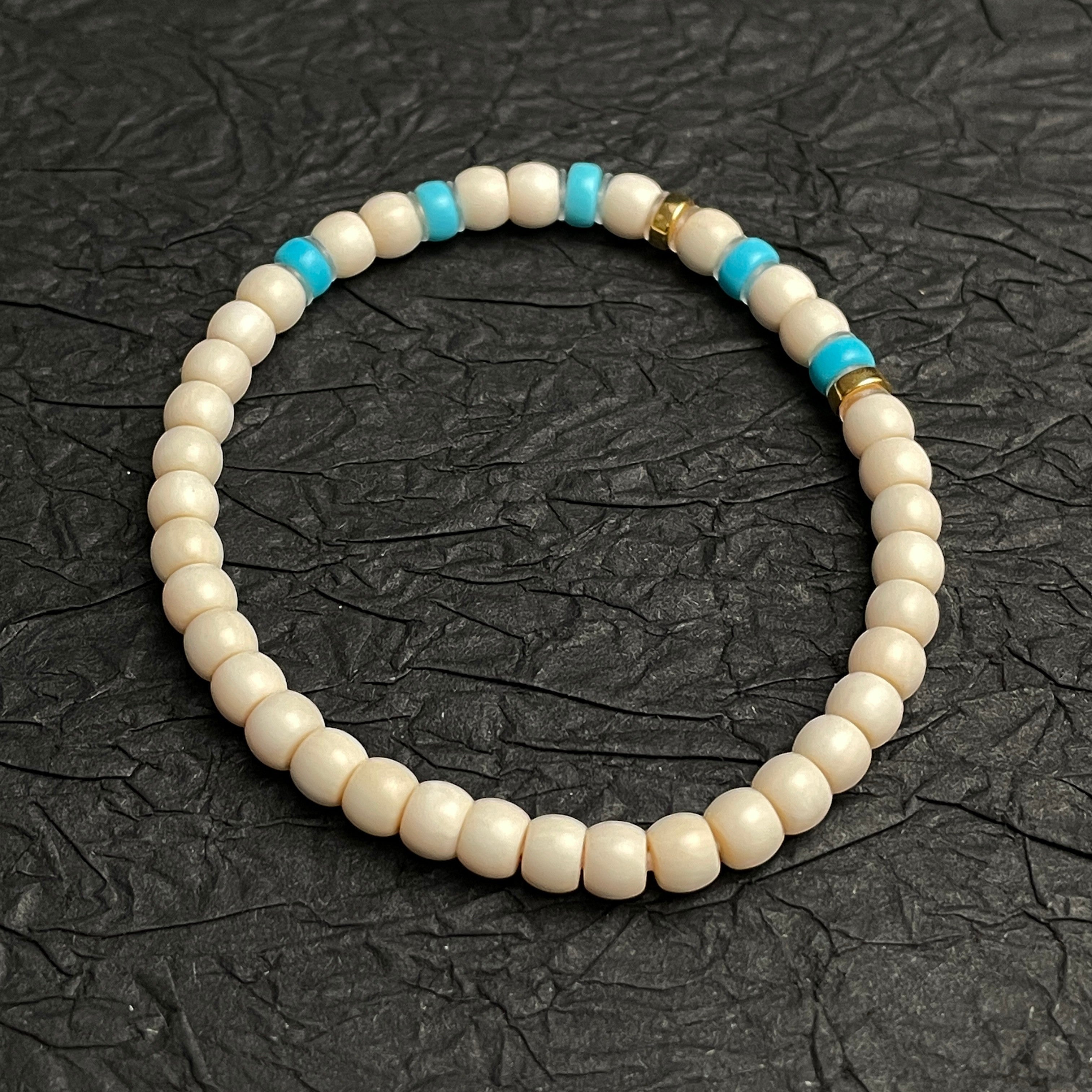 Sylvia Jewelry cream-colored beaded bracelet with turquoise accents and gold spacers, ideal for daily wear.