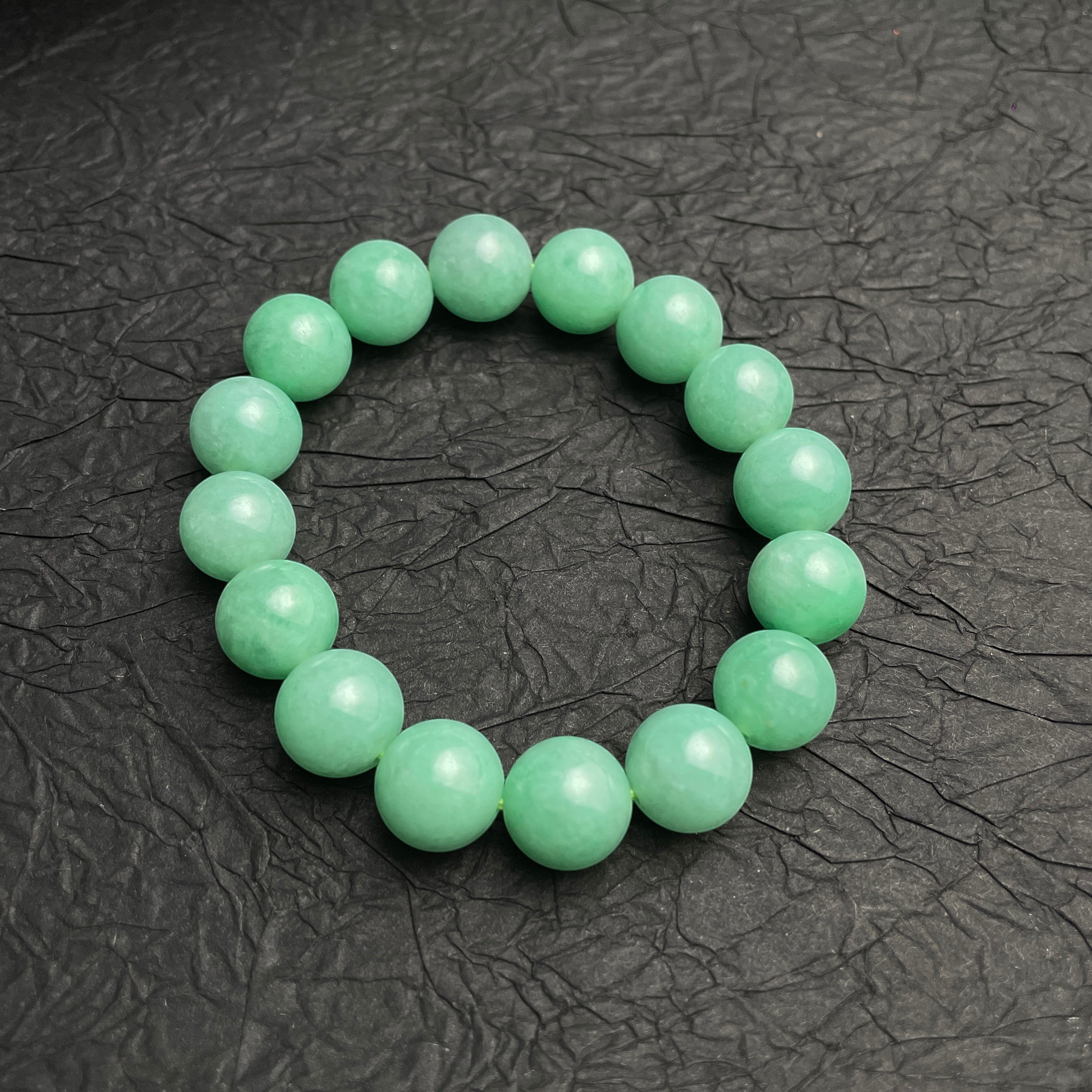 Sylvia Jewelry 14mm smooth green jadeite bead bracelet with natural luster, ideal for daily wear.