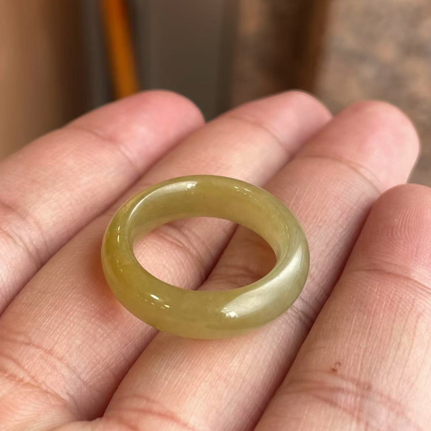 Sylvia Jewelry smooth, polished jade band ring in a translucent pale green-yellow hue.