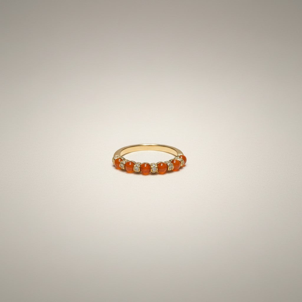 Sylvia Jewelry 18K gold ring featuring a row of smooth, warm orange jadeite cabochons alternating with small diamonds.