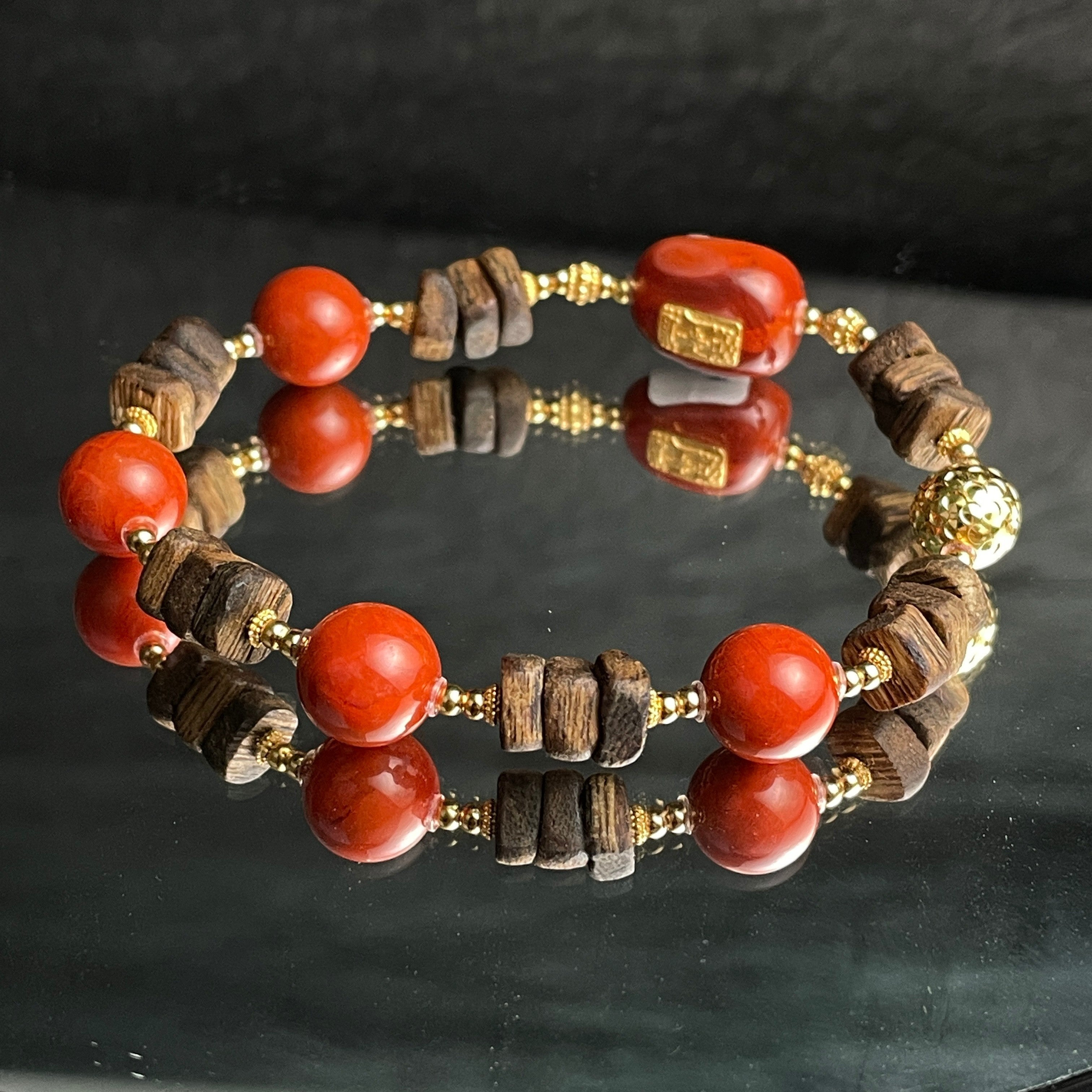 Sylvia Jewelry Nanhong Agate and Agarwood beaded bracelet with gold-plated accents. Features vibrant red agate beads and natural wood beads.